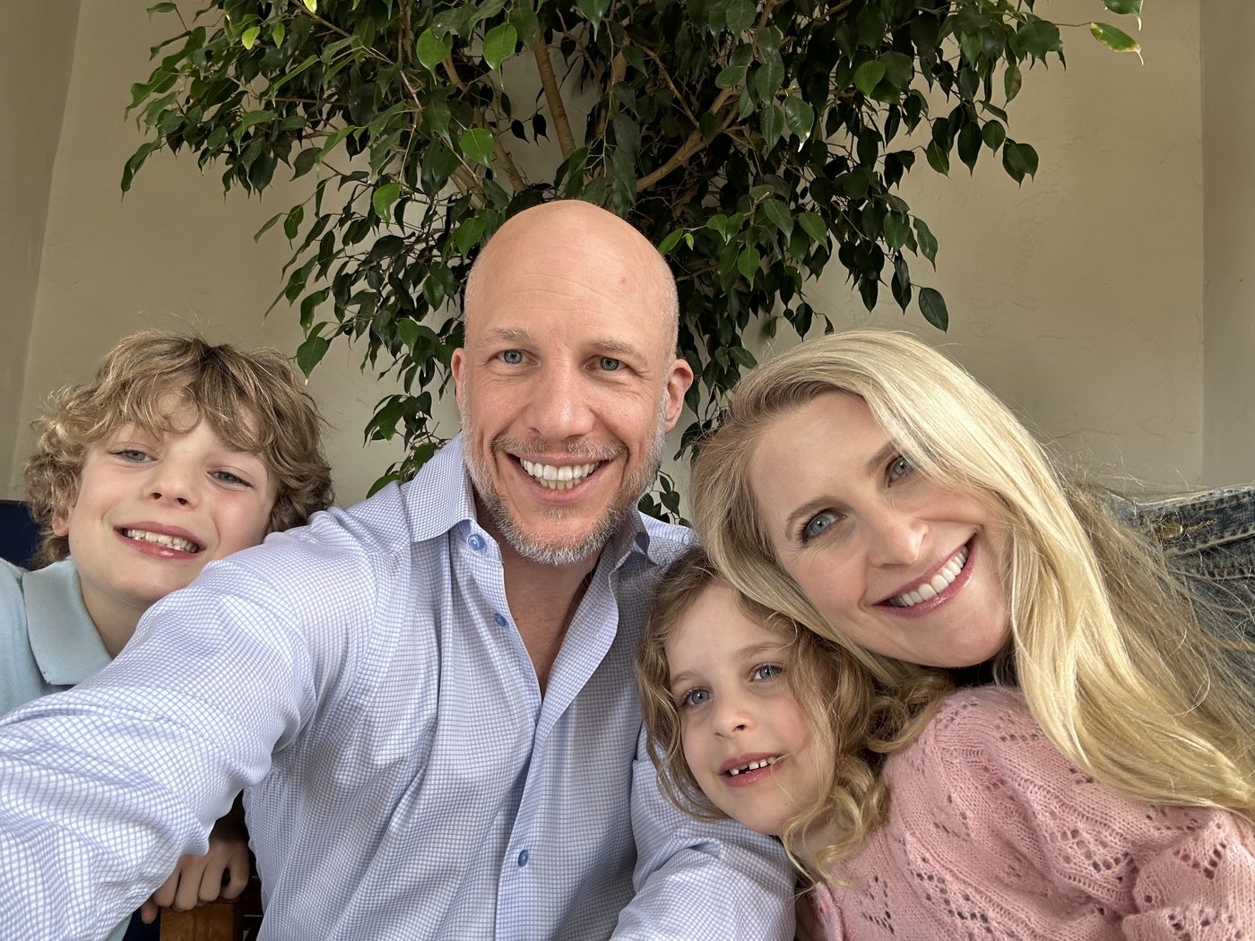 The family of four together, smiling